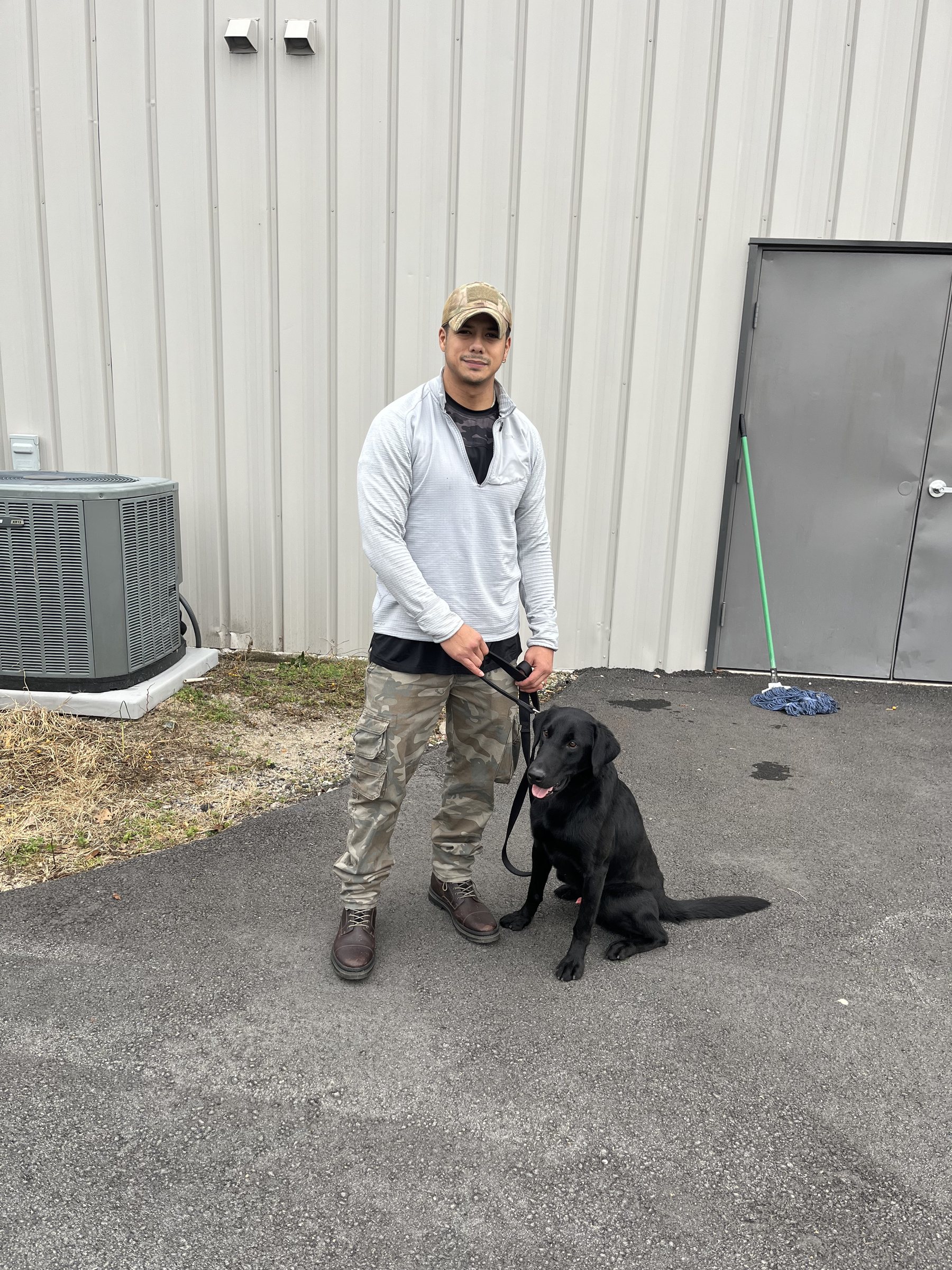 AI K9 handler with dog in the field